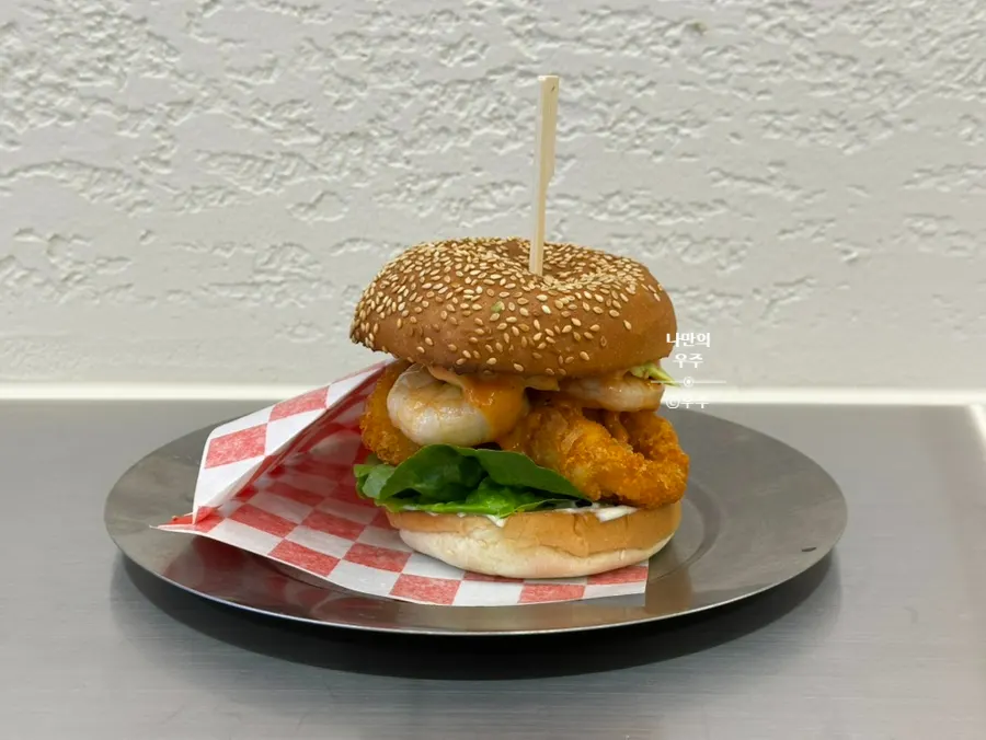 The white whole shrimp burger served at the table