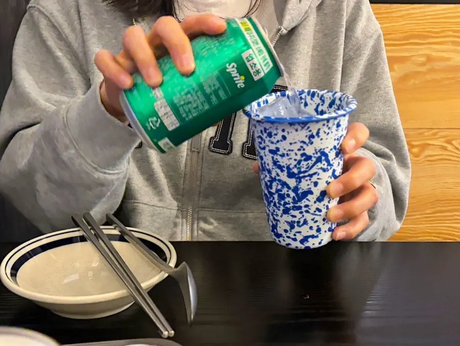 A glass of sprite next to the draft beer