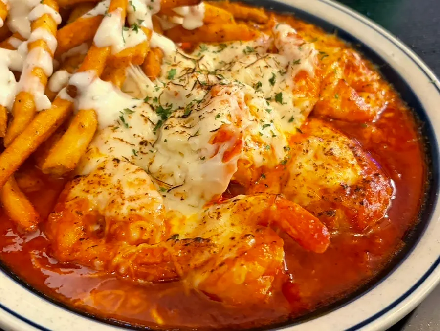Stretchy mozzarella cheese pulled from the chili shrimp