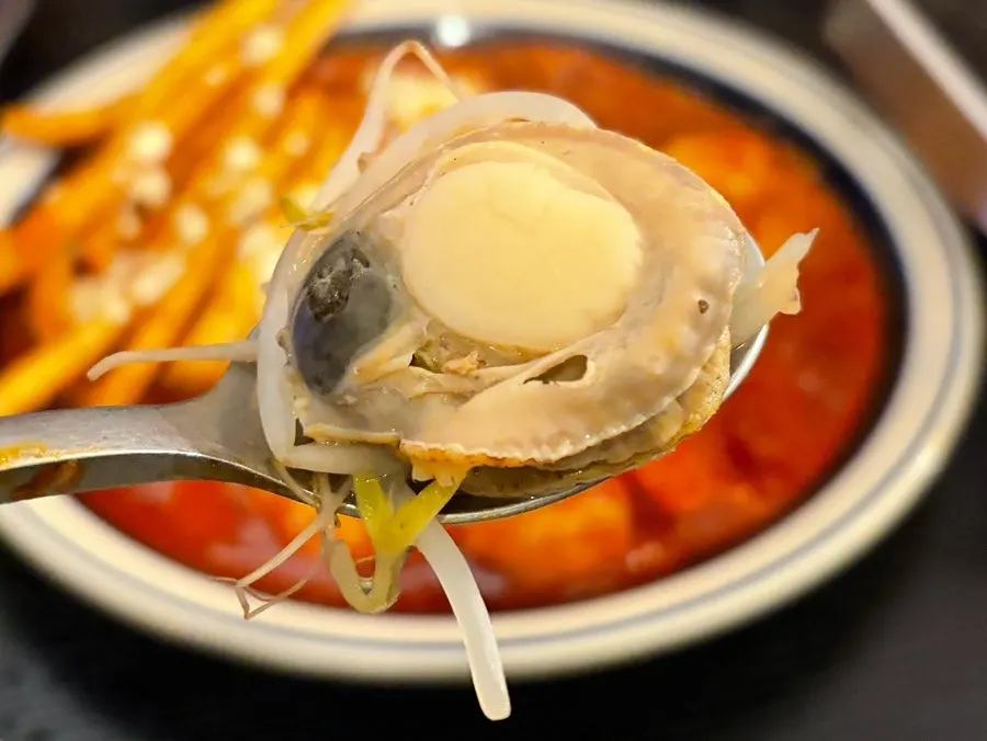 Seafood jjim served alongside drinks on the table