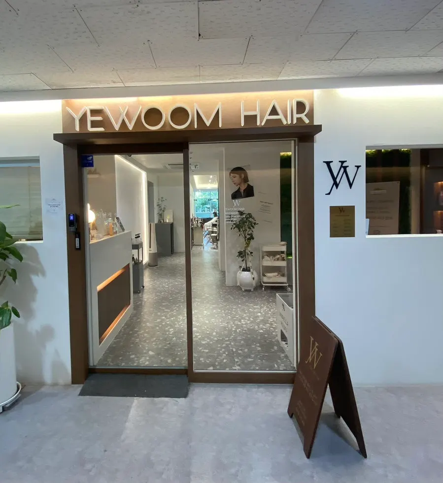 Hair salon exterior decorated in white and wood tones