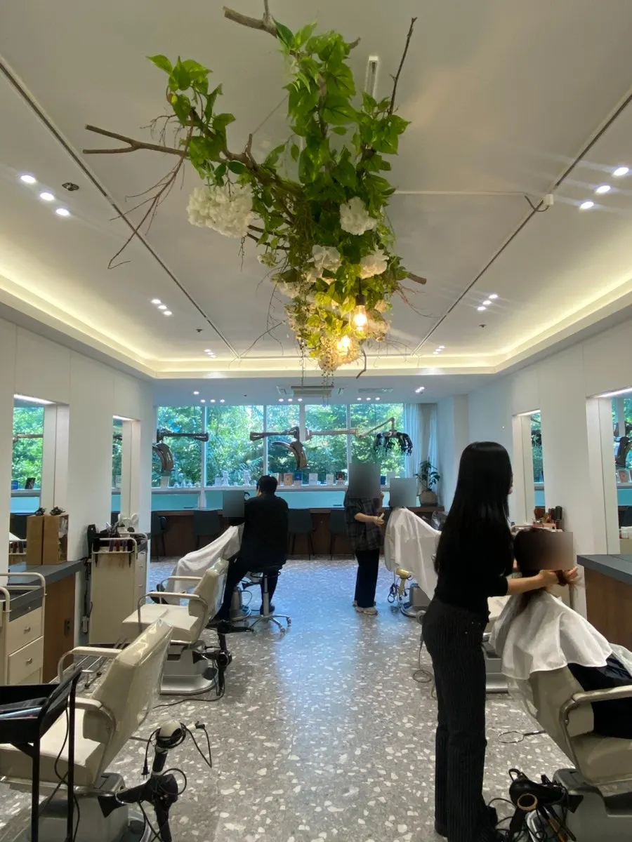 Hair salon interior decorated with white-toned lighting