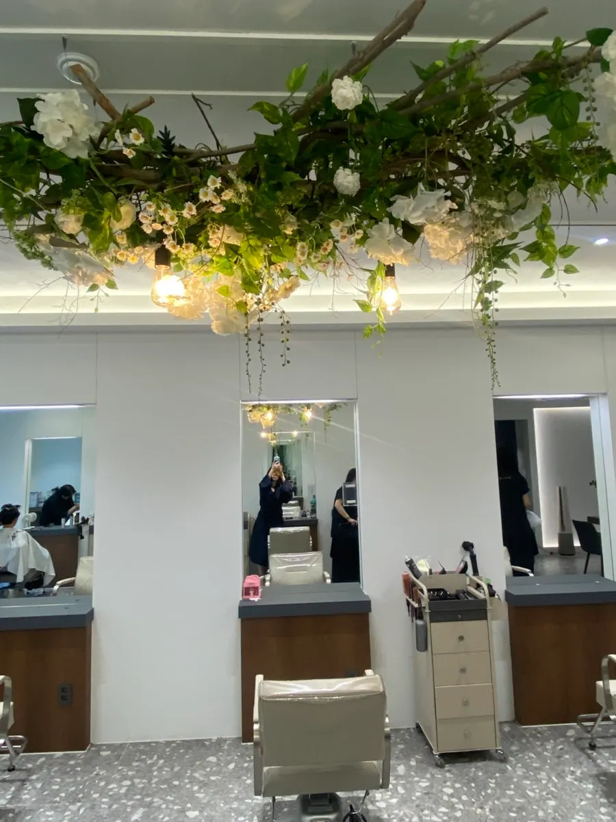 Hair salon interior with ceiling flower decorations