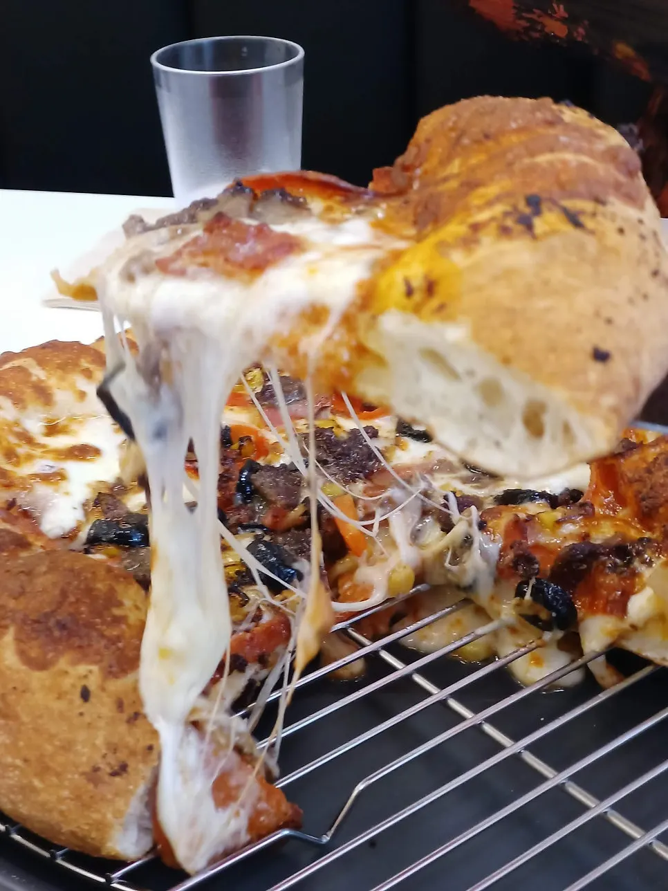 A cheese-pulling slice of combination pizza