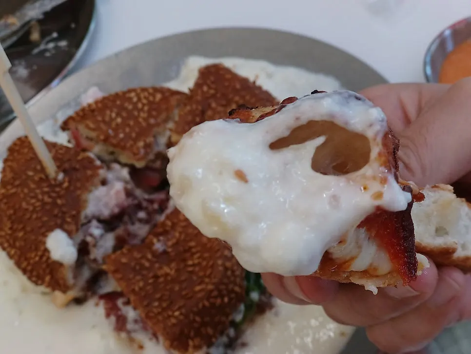 Pizza crust coated in white sauce