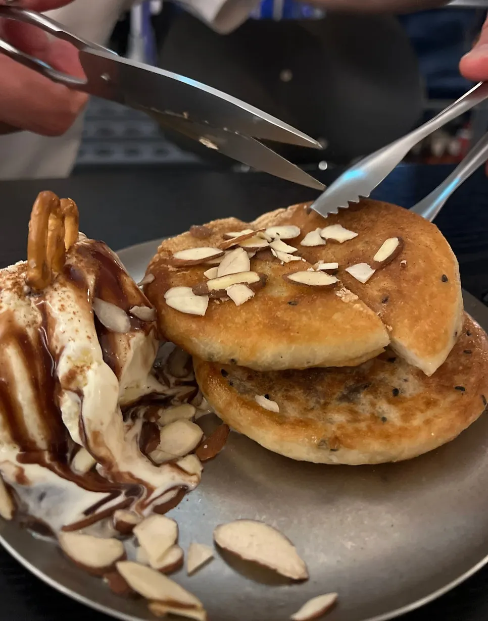 Hoddeok ice cream drizzled generously with chocolate syrup