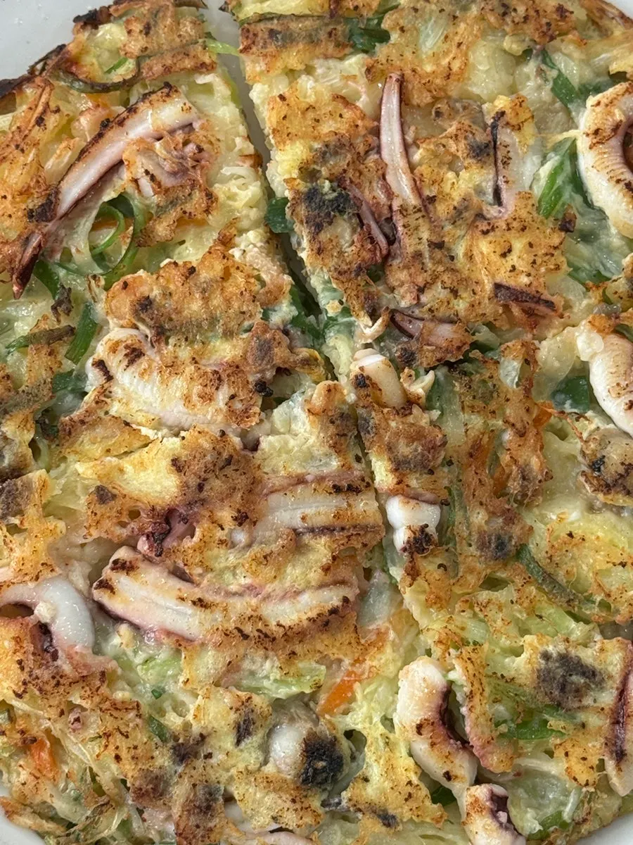 Plate filled edge-to-edge with seafood pancake