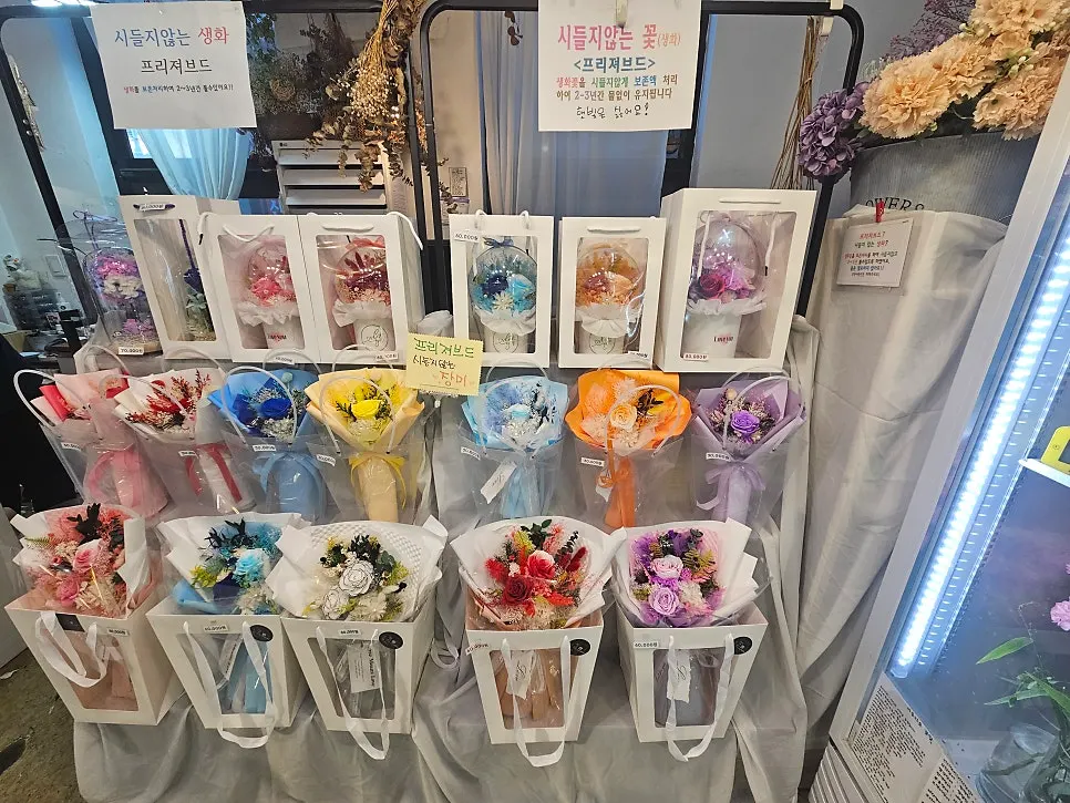 Potted plants displayed alongside the flowers