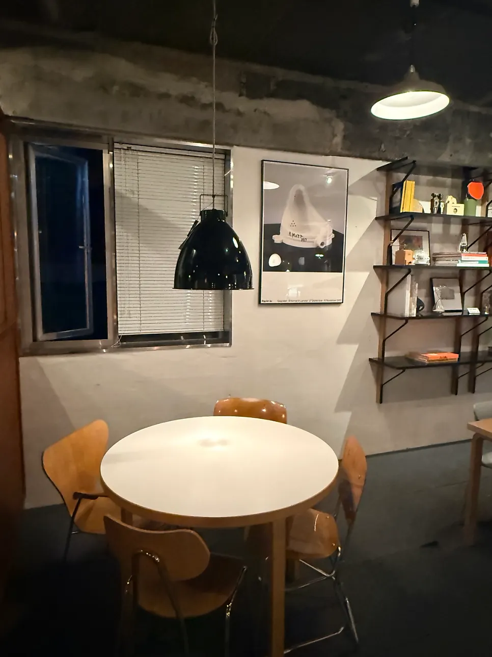 Black leather chairs facing a turntable and speaker