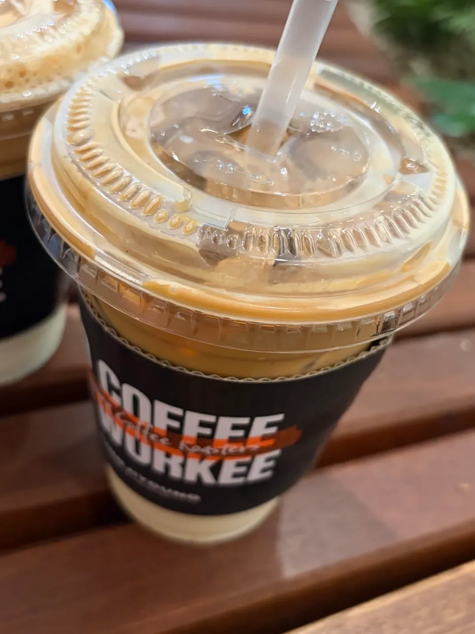 Takeout cup of nutty, strong iced caffè latte