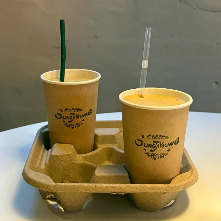 A cup of coconut coffee with foam on top