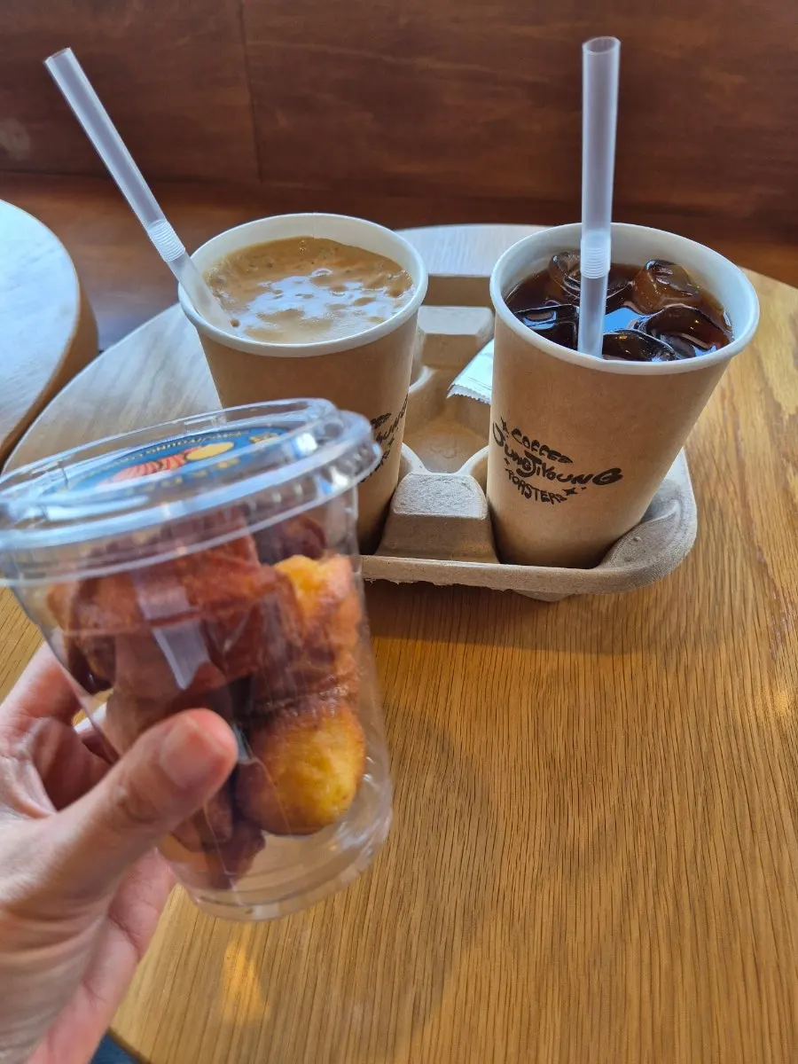 Ordered drinks and mini madeleines laid out together
