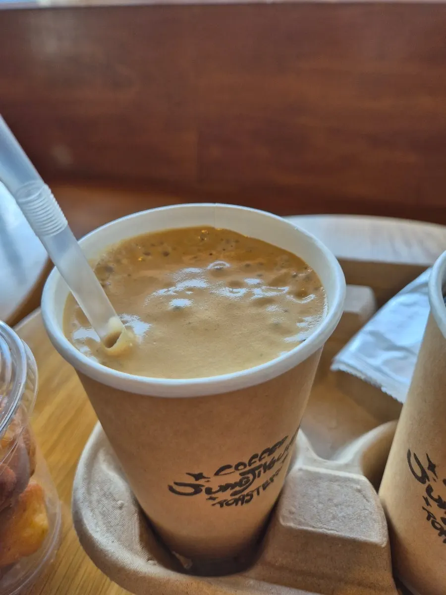 Coconut coffee being stirred with a straw