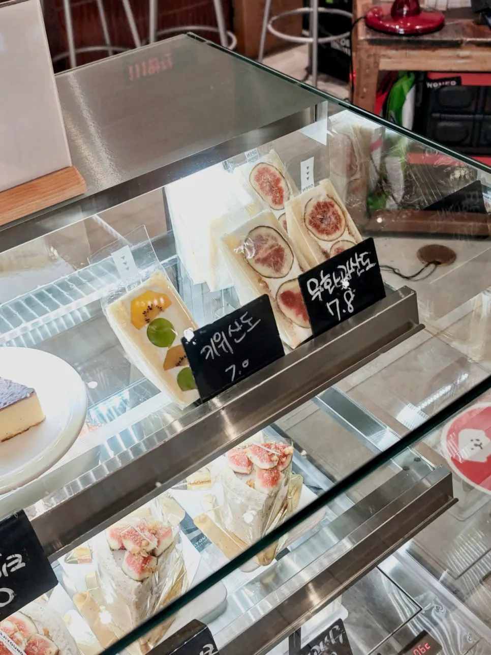 Fruit sando and madeleines in the showcase