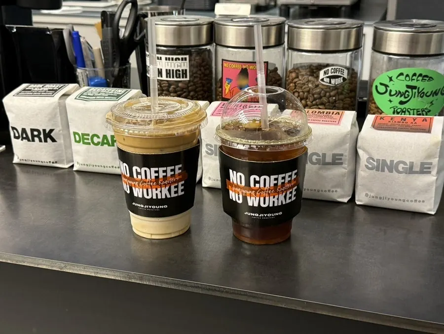 Two takeout coffees in a cup holder