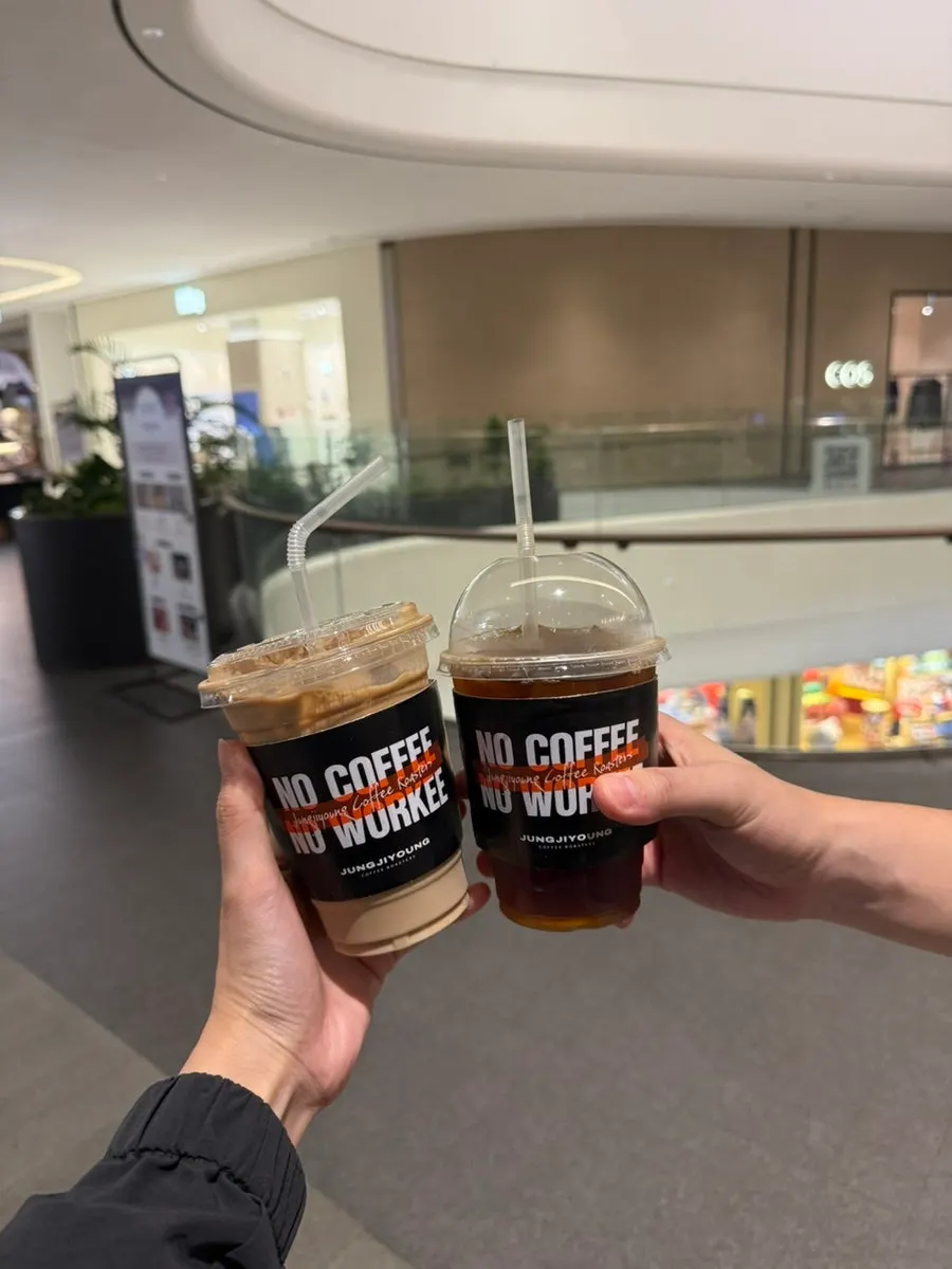 A cup of Jeong Jiyeong Coffee Roasters coffee held in hand