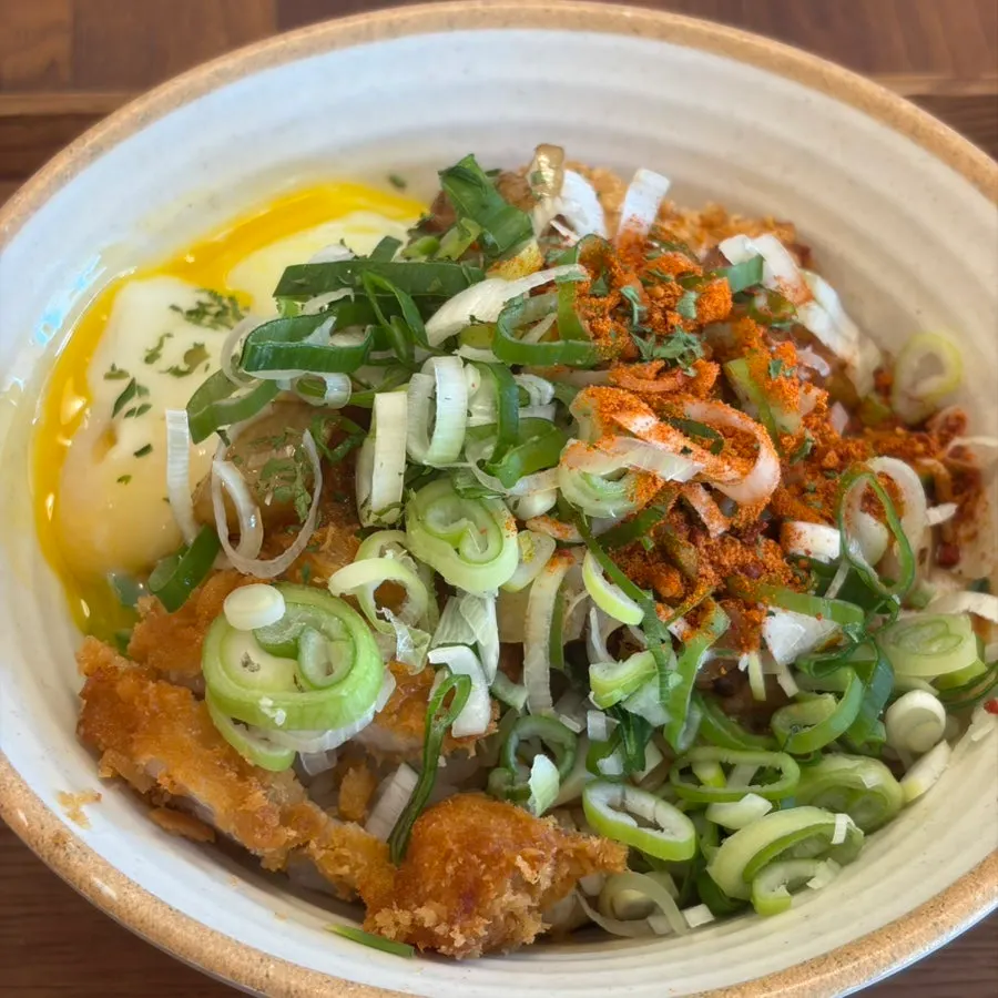 A bite of gyeongyangsik king donkatsu with sauce and rice