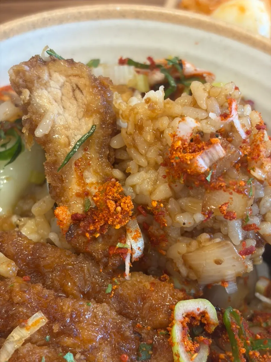 A spoonful of donkatsu don lifted up
