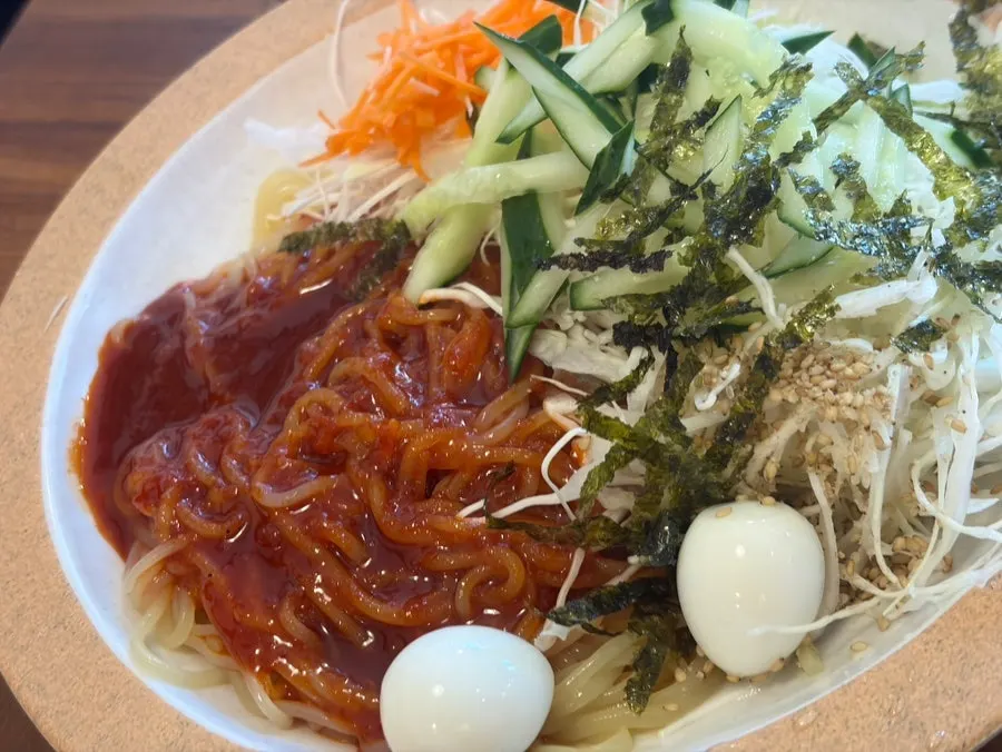 A spoonful of donkatsu don with rice