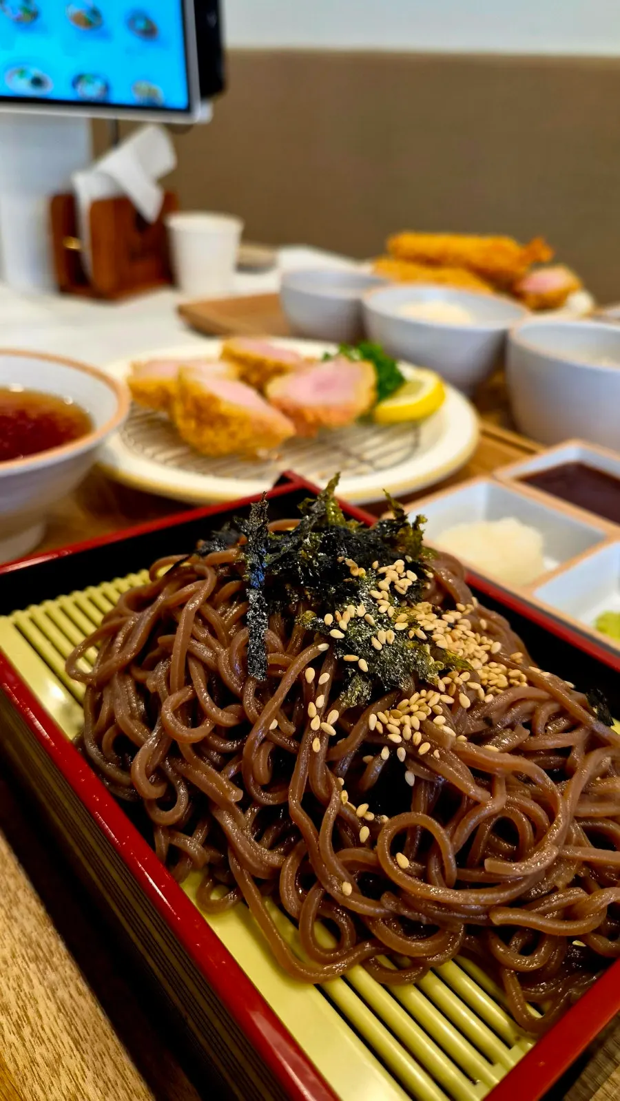 Table setting with buckwheat soba and katsu eaten together