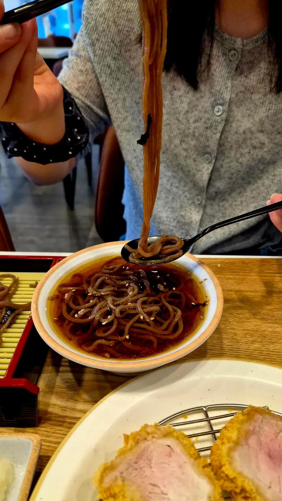 A piece of fillet katsu dipped in sauce