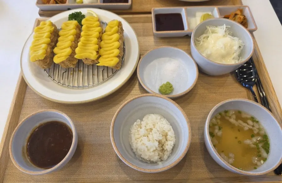 A plate of sweet potato cheese katsu set