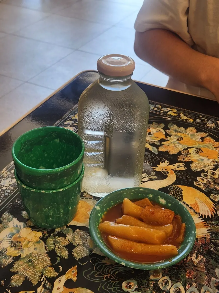 Del Monte water bottle and complimentary tteokbokki on the retro table
