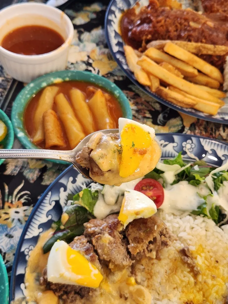 A bite of hamburg steak dipped in sauce