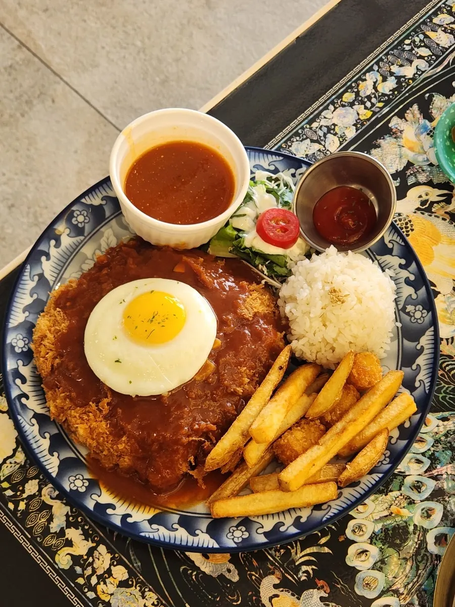 A plate of cheese pork cutlet with added spicy sauce