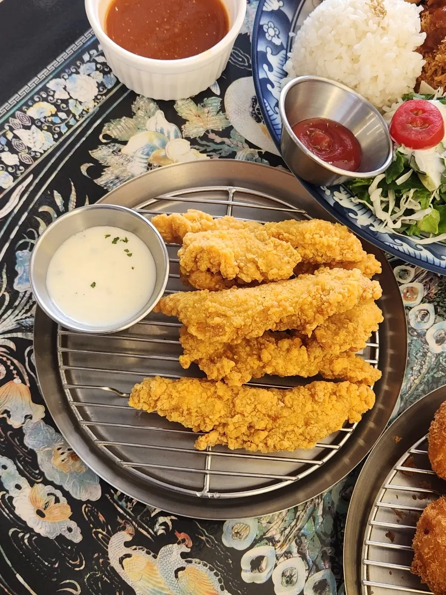 Half-and-half croquette and chicken tender ordered as sides