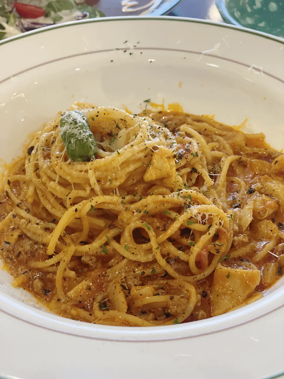 Meat tomato pasta topped with beef and cheese