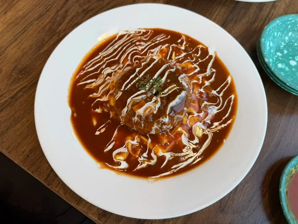 Jeongssi Hambak topped with a handmade patty and sunny-side-up egg