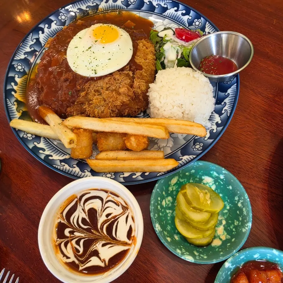 Cheese pork cutlet with a separate dish of spicy sauce