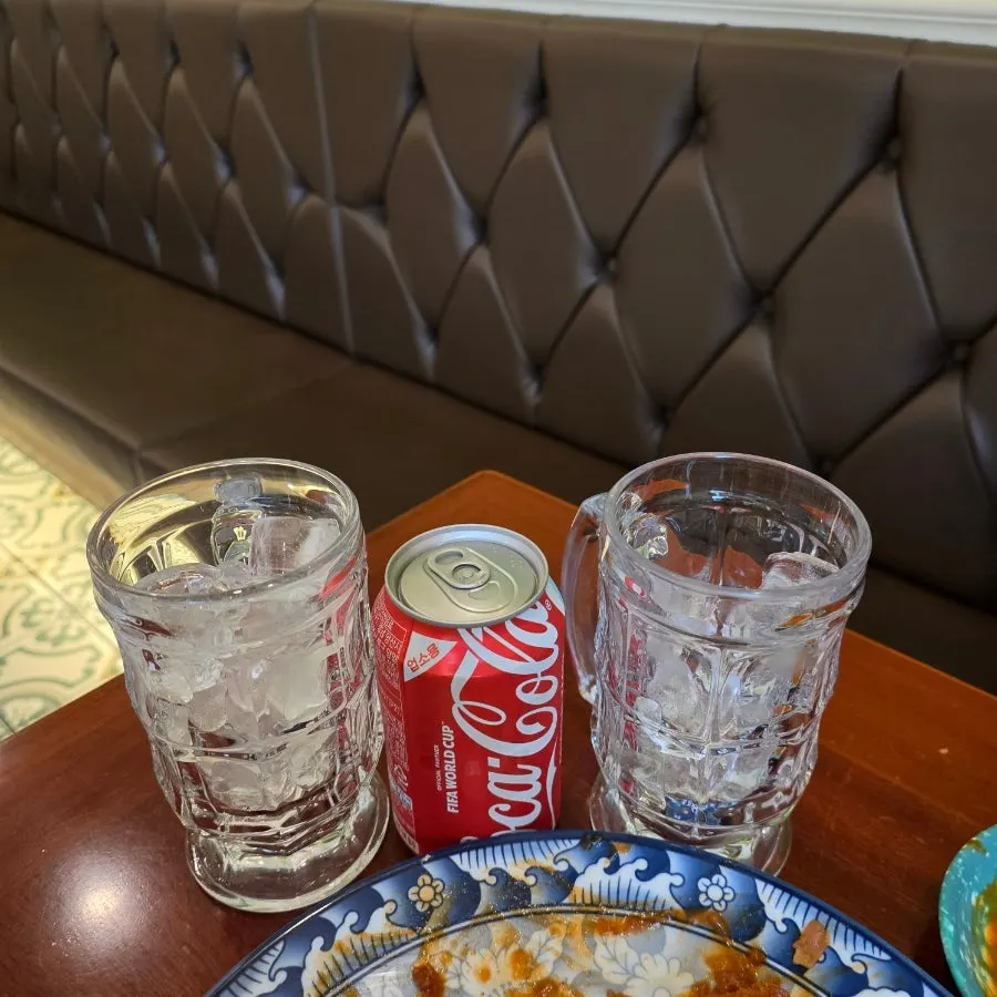 Cola served with two cups of ice