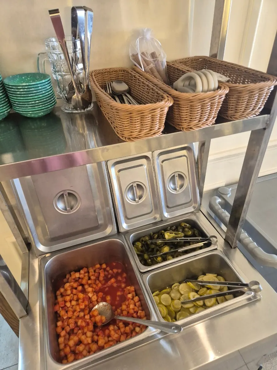 Self-serve bar with pickles and jalapeños