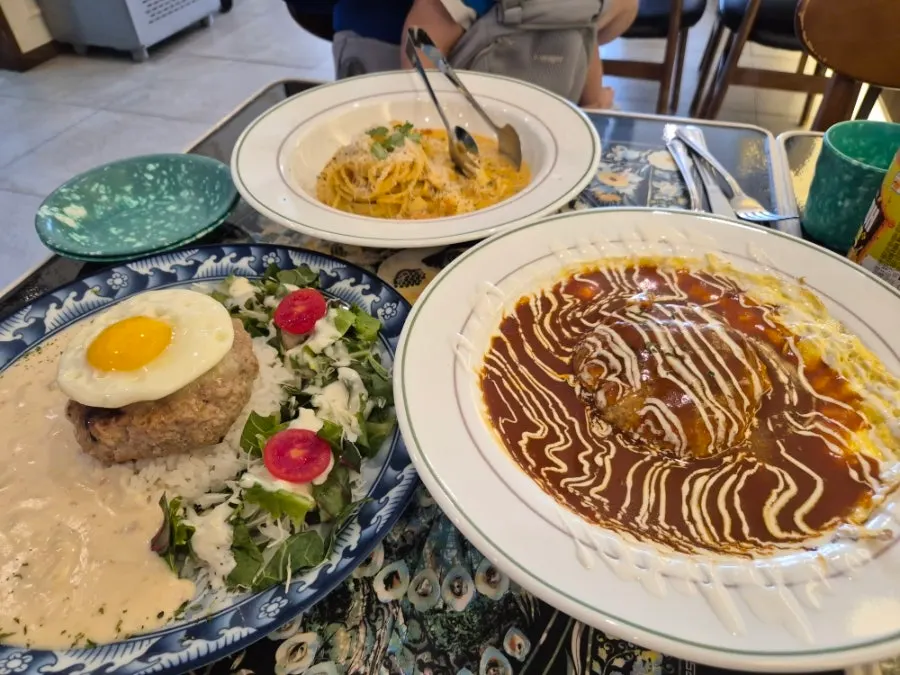 A spread of hamburg steak omurice, garlic cream hamburg, and Toowoomba pasta