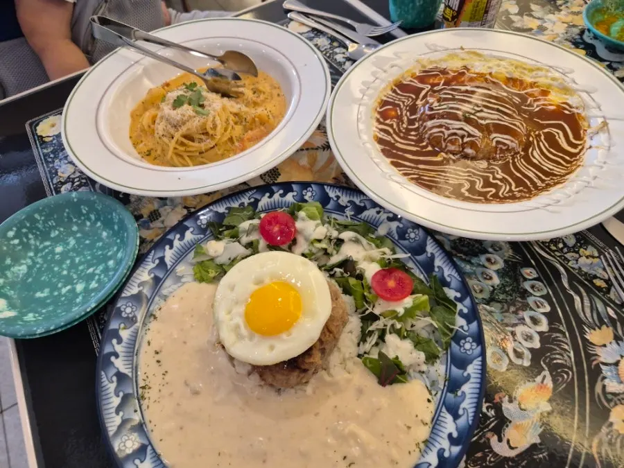 Three dishes on large plates at Jeongssi Hambak Baegot Branch