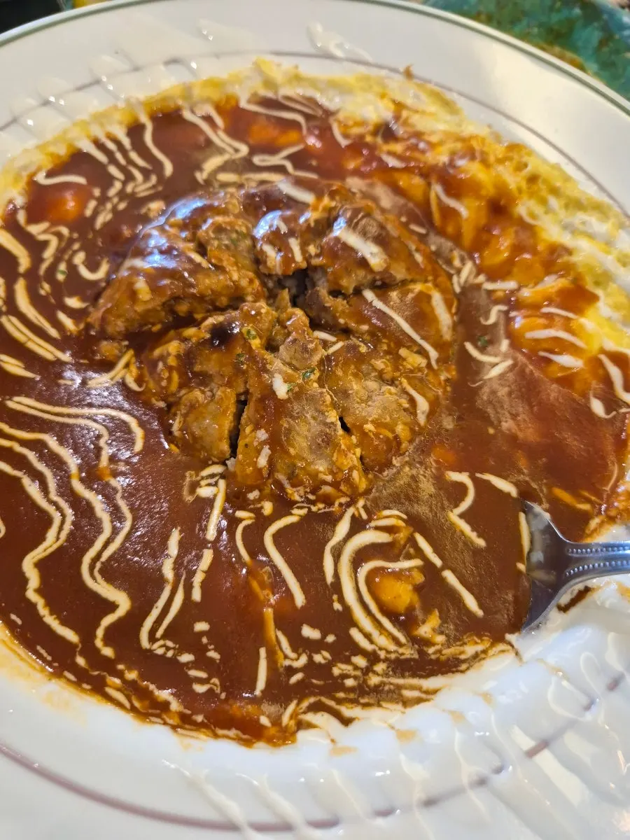 Close-up of hamburg steak omurice with the steak on top