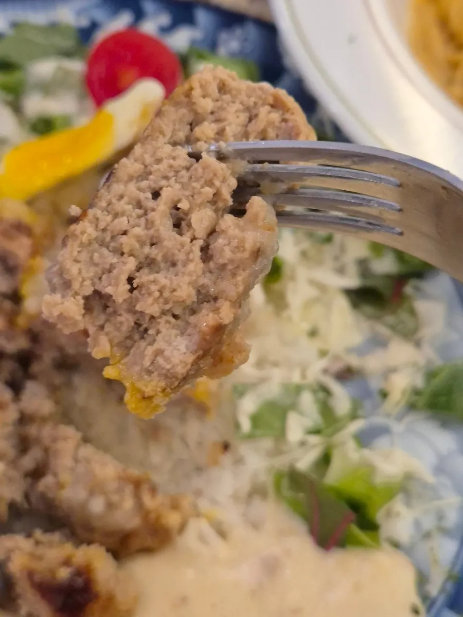 A piece of hamburg steak dipped in cream sauce