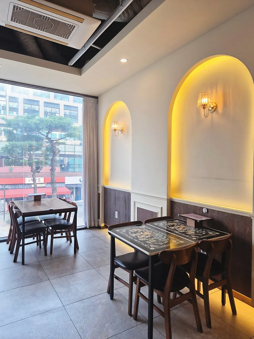 Seating area with chandeliers and a retro-patterned table