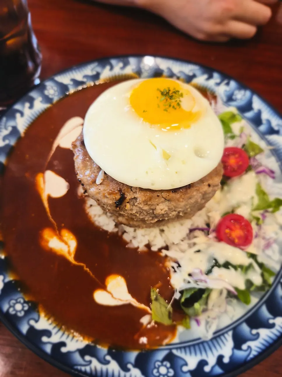 Table set with two large hamburg steak plates and bacon cream pasta