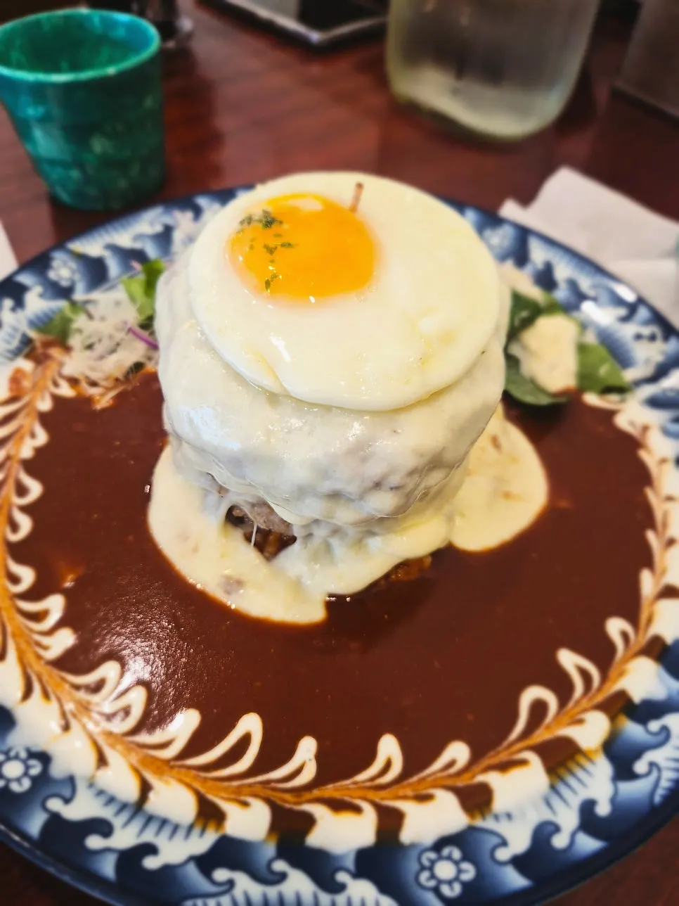 Large hamburg steak with special sauce piled generously over rice