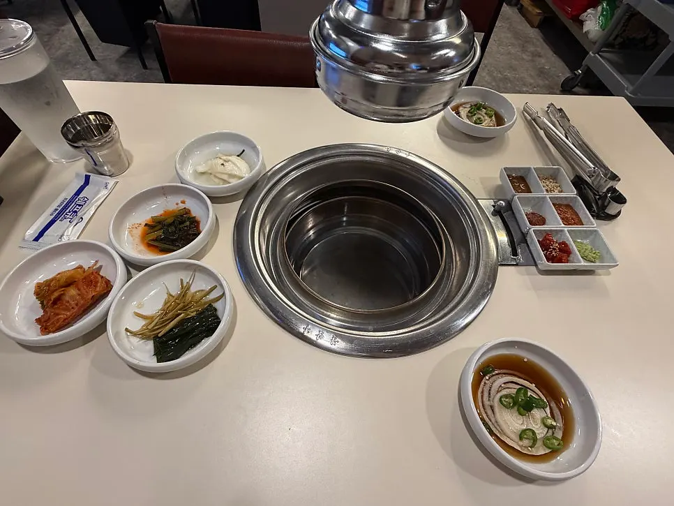 Table with samgyeopsal and beef galbi ordered via kiosk