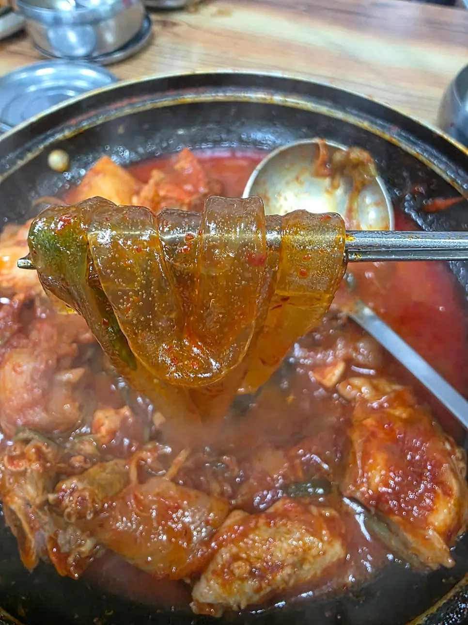 Chopsticks lifting up the glass noodles
