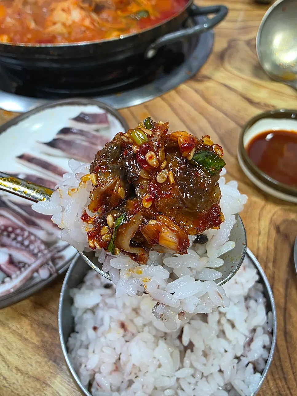 Seasoned cockles spooned over rice