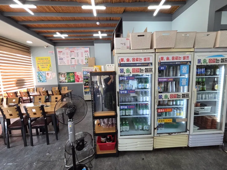 Counter on the right side of the store with takeout signage