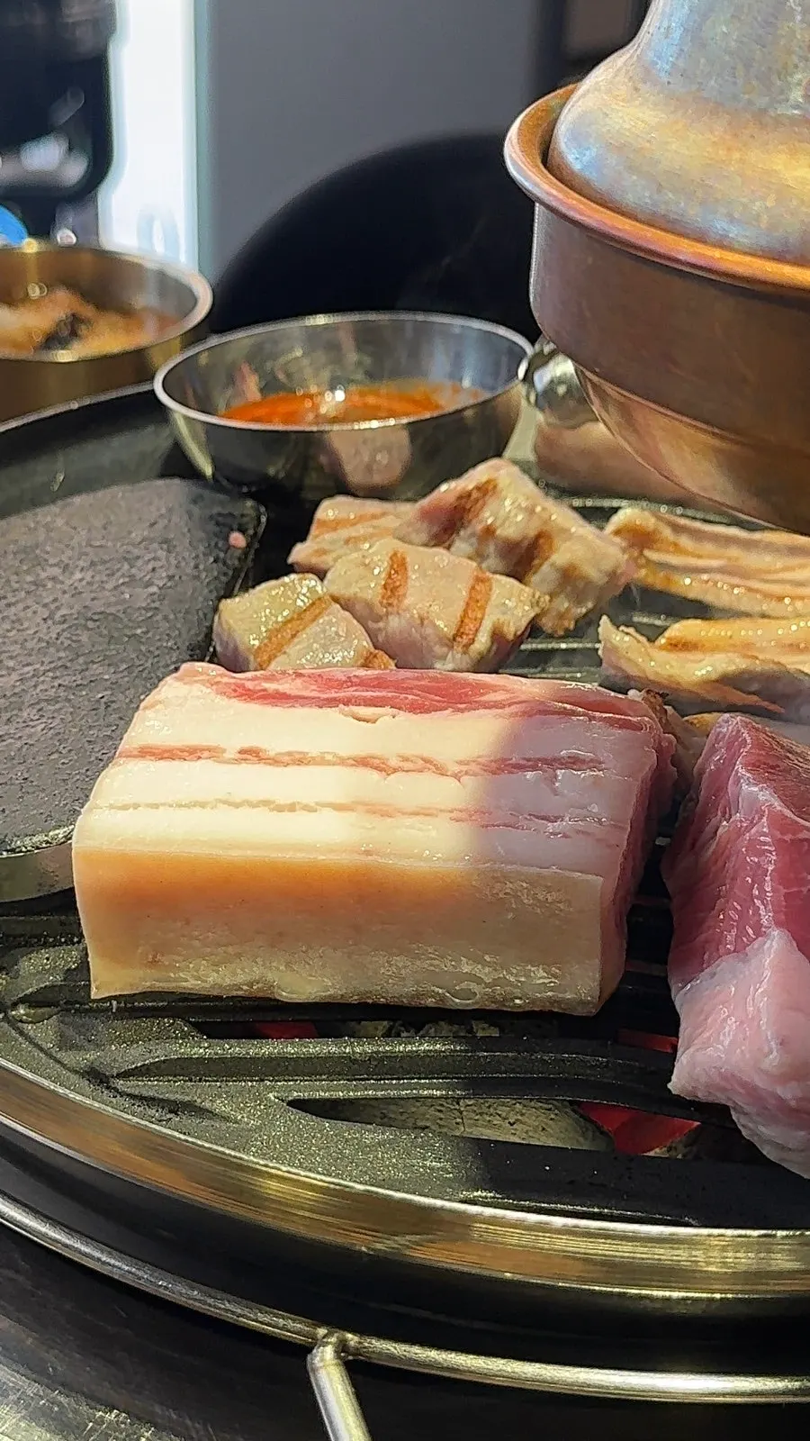 Staff member grilling Hamdon's pork tableside