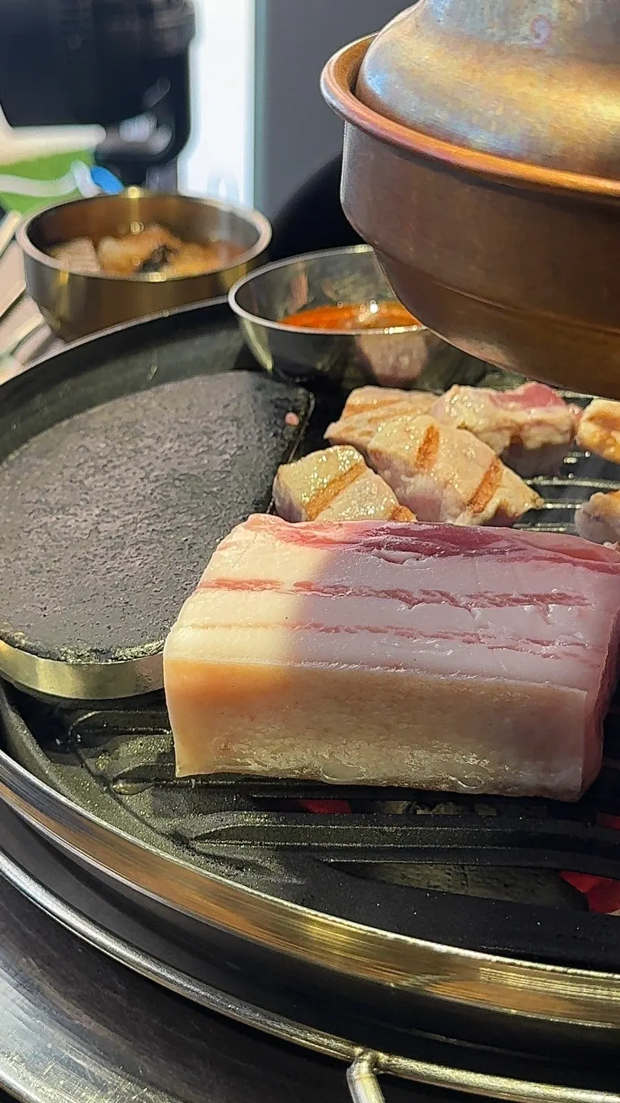 Close-up of thick pork cooking on the grill