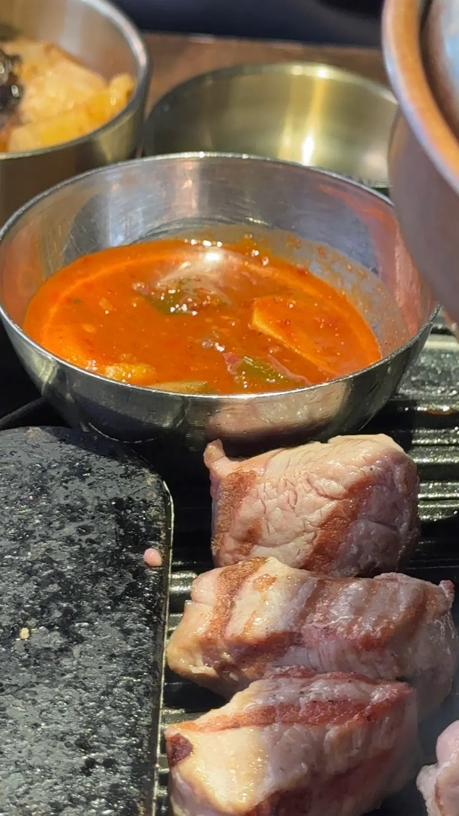 A piece of pork belly picked up with chopsticks