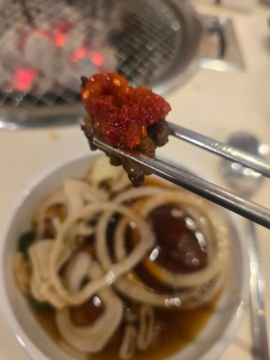 Beef galbi grilled to a golden brown, in small batches